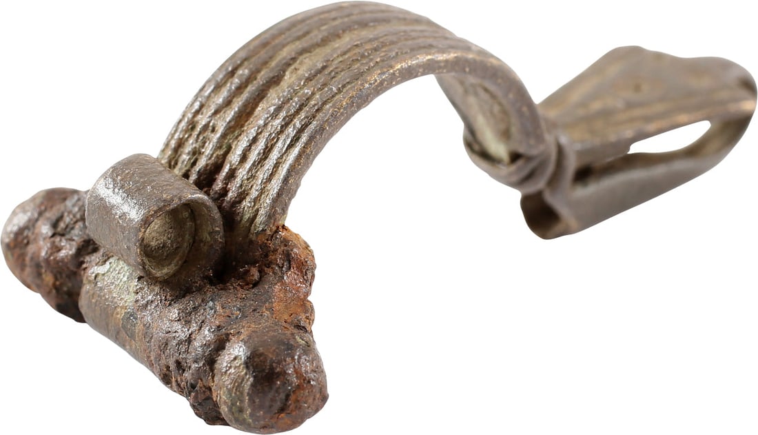 FINE ROMAN FIBULA, LATE 2ND-5TH CENTURY AD: Riha (Die romischen Fibeln aus Augst und Kaiseraugst) type B4 with tubular spring sleeve. Bronze, 2 1/8" length of elegant form, probably for a lady's garment. longitudinally reeded bow with a central