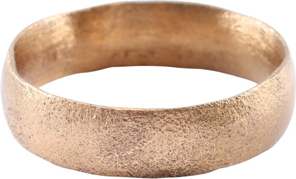 VIKING WARRIOR’S WEDDING RING, SIZE 7 ½: Cambridgeshire England, 9th-11th century AD. Gilt bronze, size 7 1/2. 4.9mm width band with rounded face. Surface textured overall from burial. Vikings exchanged rings on the pommel of the