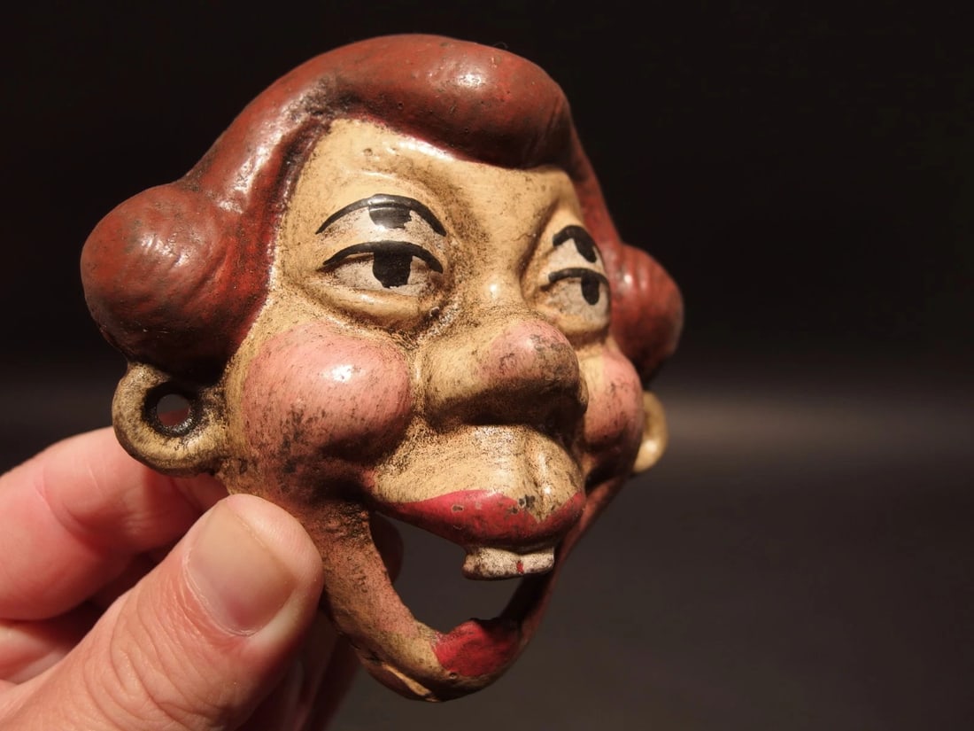 Cast Iron folk art 4 eyed Drunk Woman Wall Bottle Opener: 3 5/8" Tall x 3 1/2" Wide Great reproduction cast iron bottle opener. This piece was made to look just like an antique, but is new. Reserve: $18.00 Shipping: