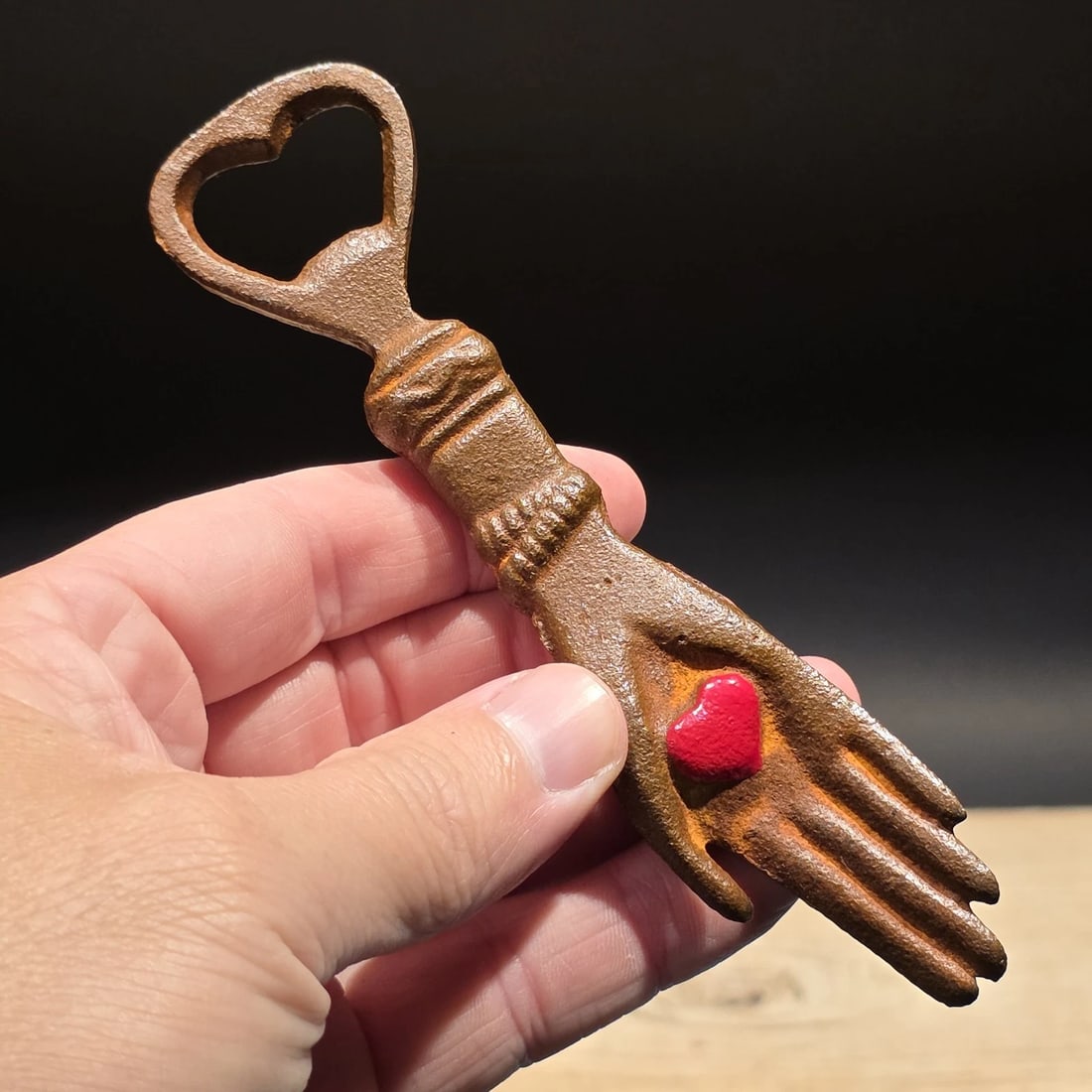 Cast Iron Heart in Hand Odd Fellows Bottle Opener: 5 3/4" long x 1 1/2" Wide A wonderful reproduction cast iron heart in palm bottle opener. Many times the symbol of a heart in an open palm is symbolic of an open welcome or charity. It has also been