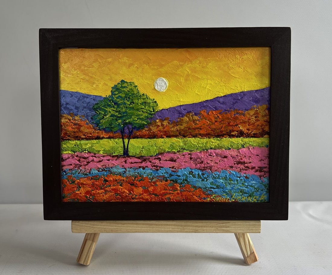 Oil painting In the shadows of the tree V. Zadorozhnya: NoAAA4561The painting "In the Shadows of the Tree" captures a mesmerizing landscape bathed in warm golden light, where a lone tree stands as a focal point amid a riot of vibrant colors. The compositio