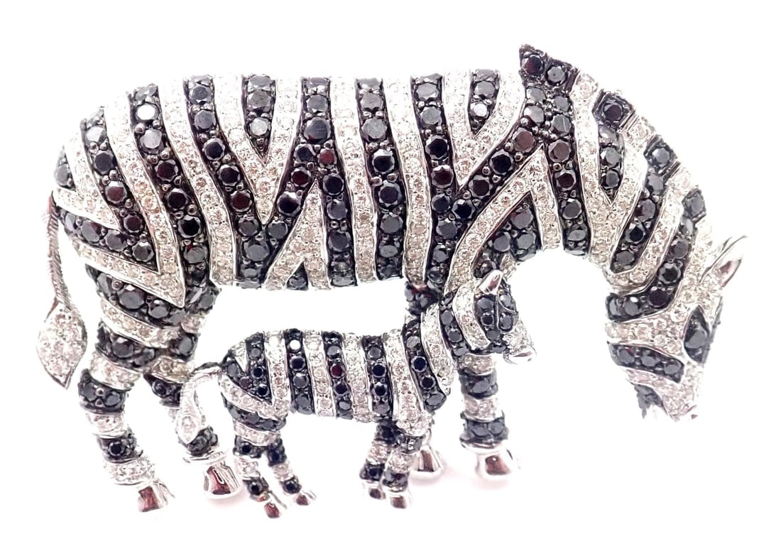 Authentic! Michele Della Valle 18k White Gold White & Black Diamond Zebra Brooch: Authentic! Michele Della Valle 18k White Gold White & Black Diamond Zebra Brooch About This Piece: Modeled as mother and baby zebra, the mother's tail is moving. Metal: 18k White Gold Measurement: 50m