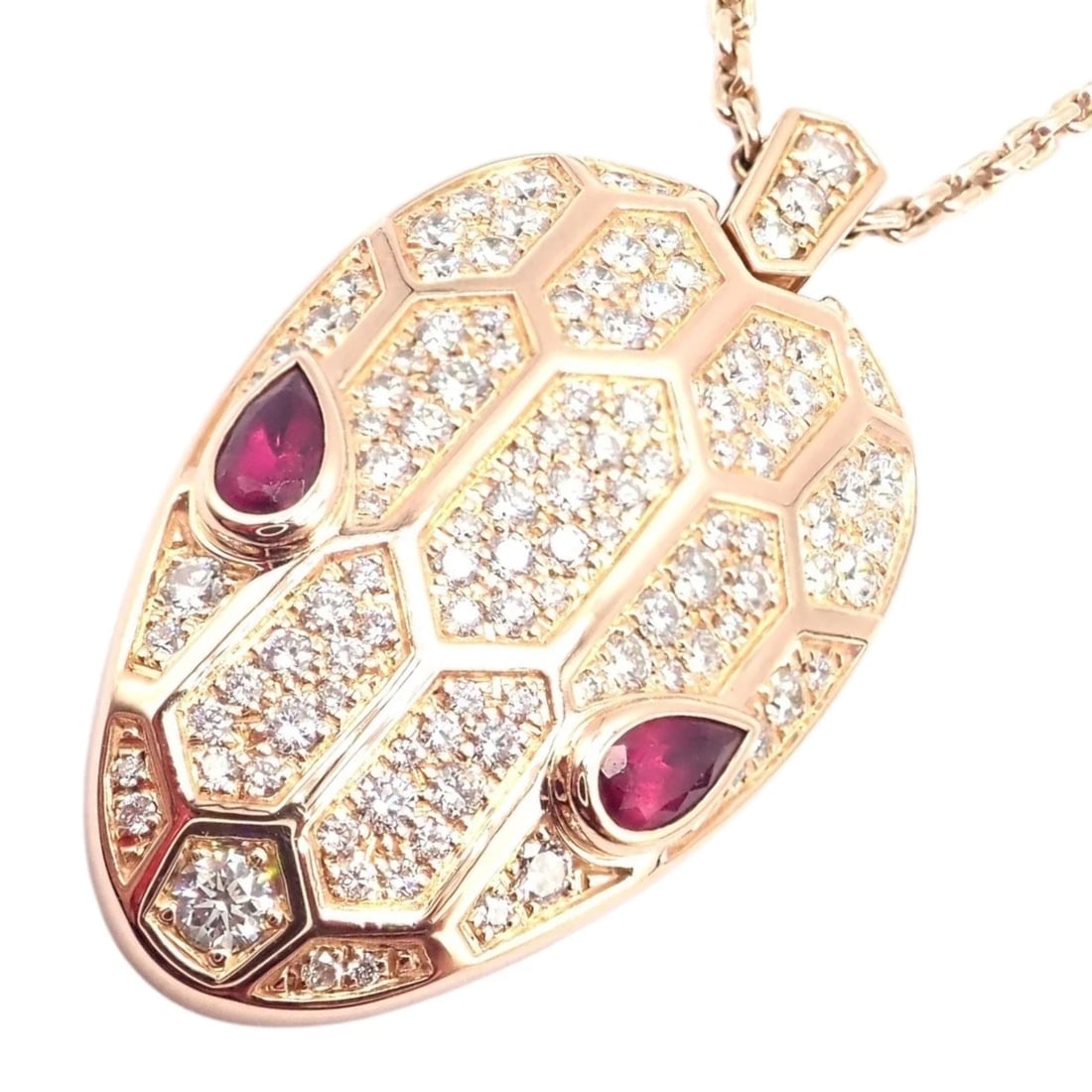 Authentic Bulgari Bvlgari Serpenti 18k Rose Gold Pave Diamond Rubellite Necklace: The Bulgari Serpenti necklace in 18k rose gold features a serpent head pendant adorned with pavé diamonds and vivid rubellite gemstone eyes. Its elegant chain is accented with diamond-set links, 