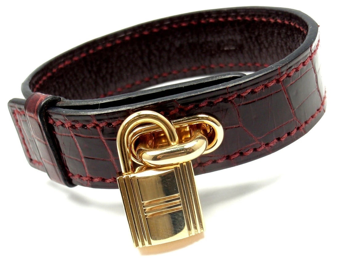 Very Rare! Authentic HERMES 18k Yellow Gold & Crocodile Burgundy Bracelet: Very Rare! Authentic HERMES 18k Yellow Gold & Crocodile Burgundy Bracelet About This Piece: Metal: 18k Yellow Gold Measurements: Length: 7" Width: 15mm Weight: 25.7 grams Lock: 18k yellow gold 22mm x 