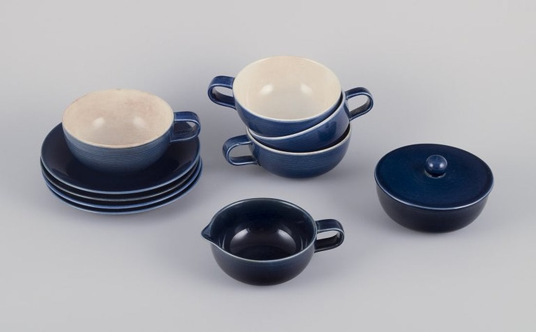 Gertrud Lönegren for Rörstrand, Sweden. Set of four 'Blå Blanche' teacups with: Title: Gertrud Lönegren for Rörstrand, Sweden. Set of four 'Blå Blanche' teacups with saucers, a sugar bowl, and creamer. Faience. Circa 1960s. Description: Gertrud Lönegren for