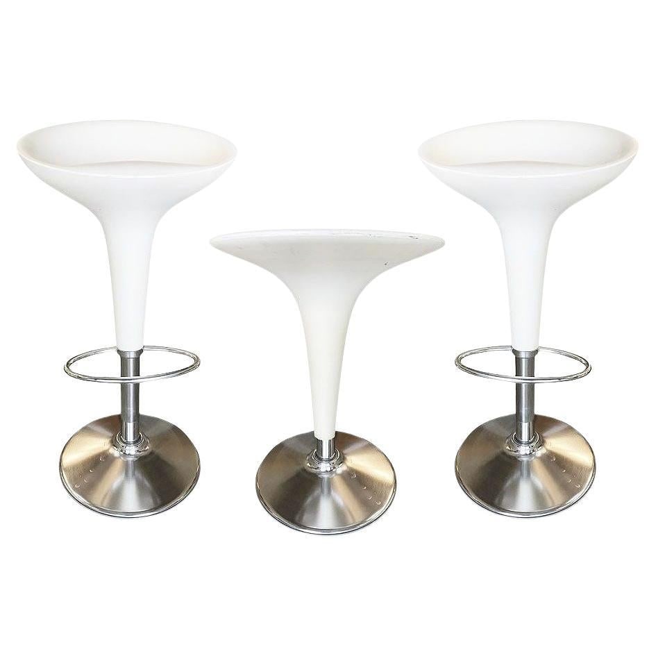 Philippe Starck Style White Modernist Stool and Table Set: Title: Philippe Starck Style White Modernist Stool and Table Set Description: Philippe Starck-style white modernist stool and table set featuring white plastic tops and chromed steel bases. The set