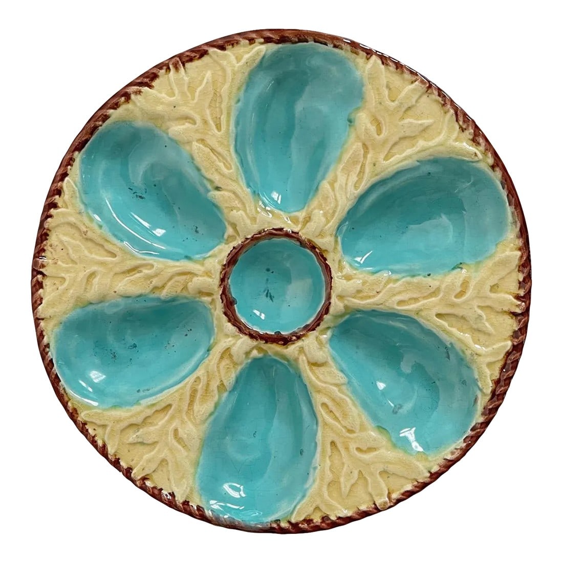 19th Century English Fielding Majolica Oyster Plate: A 19th Century English glazed majolica oyster plate with six turquoise blue oyster wells surrounding a center well for sauce on a yellow ground with seaweed relief. A brown nautical rope border