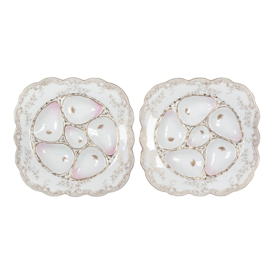19th Century Wilhelm & Graef Porcelain Oyster Plate Pair: A pair of Wilhelm & Graef porcelain oyster plates with five pale pink wells and a center well for sauce. Wide square rim with delicate gold foliate decoration. Mark to underside: Wilhelm & Graef New