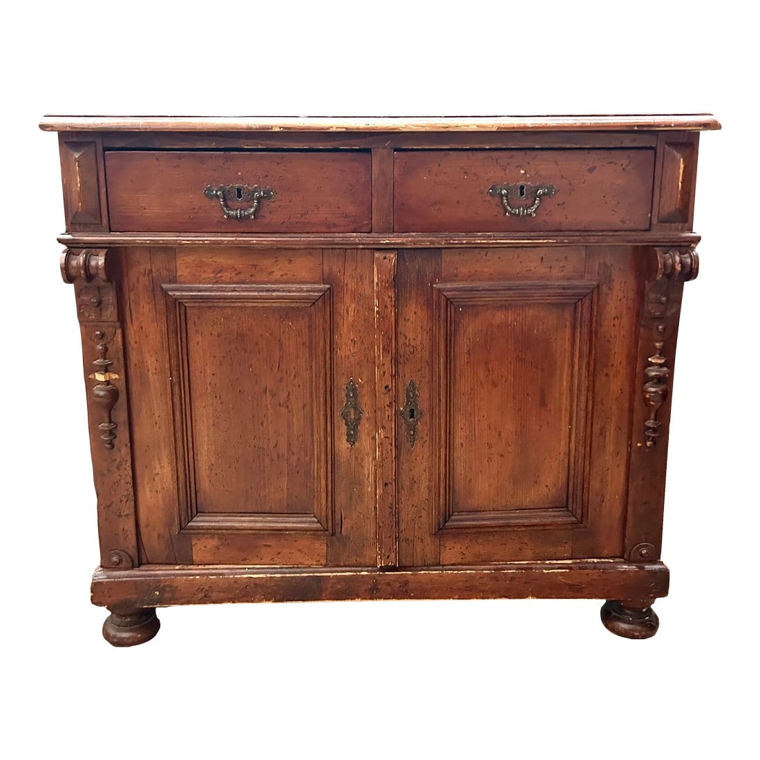Antique Eastern European Sideboard Cabinet: A charming and functional antique eastern European pine sideboard cabinet with original pulls. Offers plenty of storage space with 2 drawers and two doors that open to reveal a storage area with a