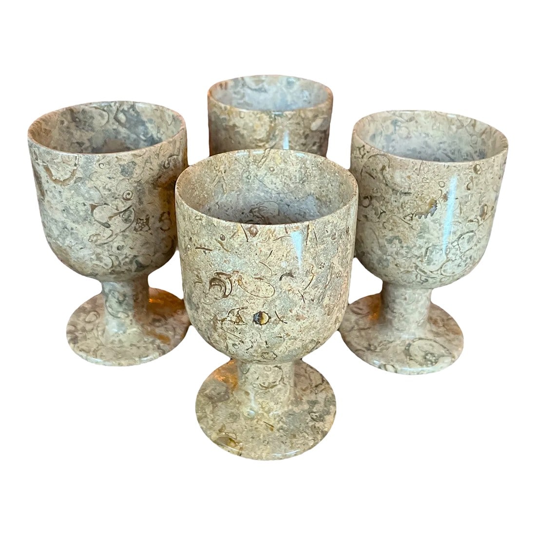 1970s Fossilized Italian Marble Stone Wine Goblets- Set of 4: Set of four stone goblets made from a beautifully textured and polished natural stone, likely fossilized marble. Each goblet features a unique pattern of fossil imprints and veining, showcasing the
