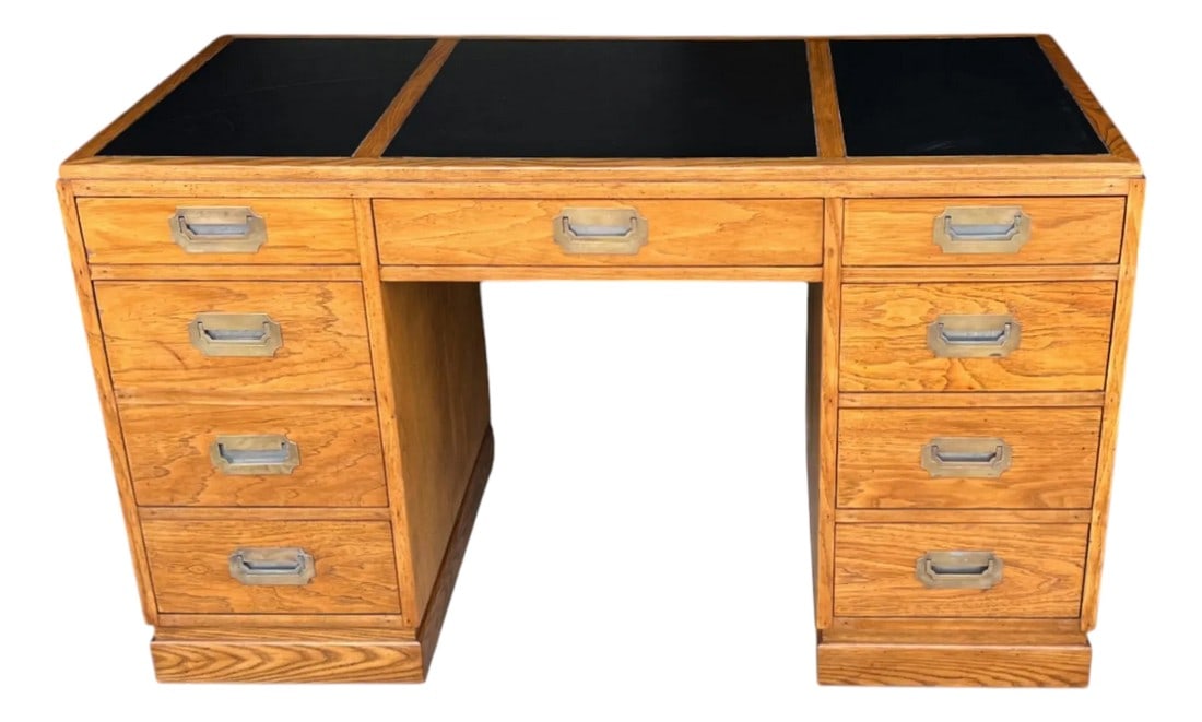 Restored Mid-Century Campaign Desk in Solid Oak With Black Inlay & Brass Pulls: A striking blend of durability and timeless design, this vintage mid-century Campaign-style desk has been expertly restored by our professional craftsmen to reveal its full character and charm.