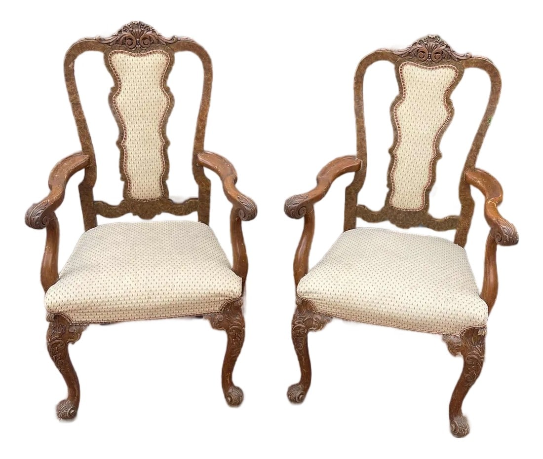 1930s Carved Queen Anne Pair of Armchairs: Elevate your dining space or add a touch of classic elegance to any room with this exquisite pair of antique Queen Anne style armchairs. Crafted from rich, dark walnut with beautifully carved details