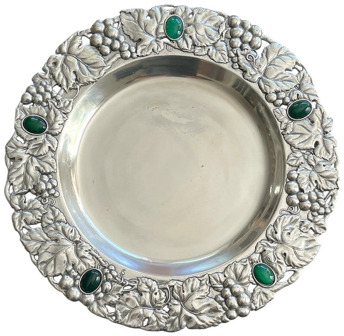 1990s Arthur Court 14" Repousse Pewter Platter With Imitation Malachite Cabochons: A 14-inch platter by Arthur Court that captures the brand's signature blend of sculptural artistry and timeless function. The wide repoussé border features lush grape clusters and curling vine
