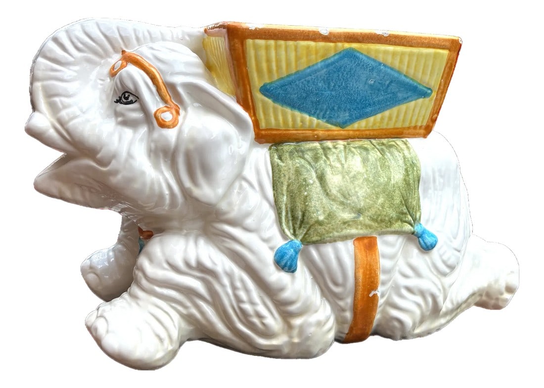 Large 1960s Porcelain Kneeling Elephant Planter by Napcoware Made in Japan: A delightful mid-century porcelain elephant planter by Napcoware, Japan, circa 1960s. This charming piece features a kneeling white elephant with expressive eyes and raised trunk "” a