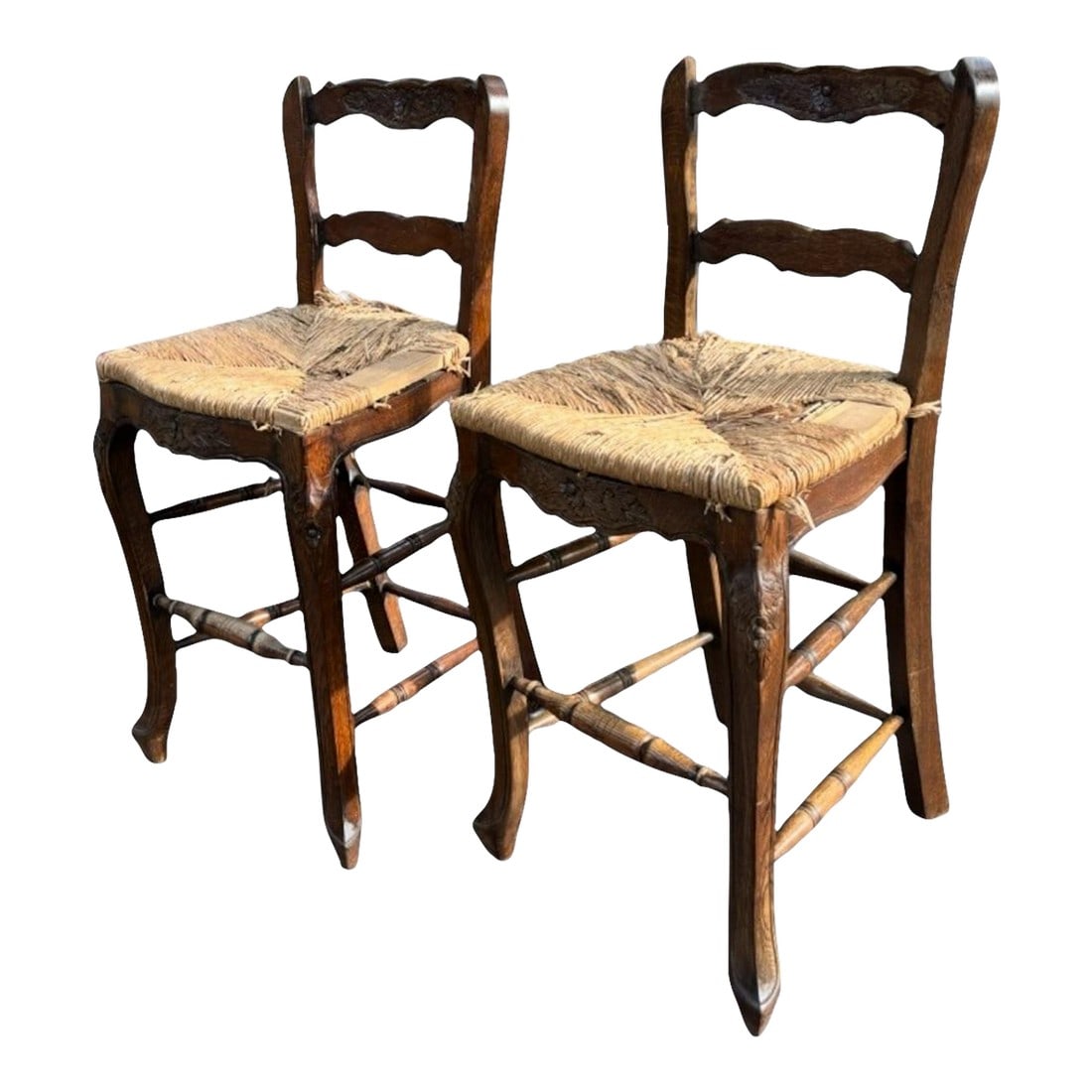Pair English Country Rush-Seat Chairs "” Hand-Woven Seats: A charming pair of mid-century French Country counter-height barstools, beautifully hand-carved and full of authentic rustic character. Crafted from solid oak with floral relief carving along the