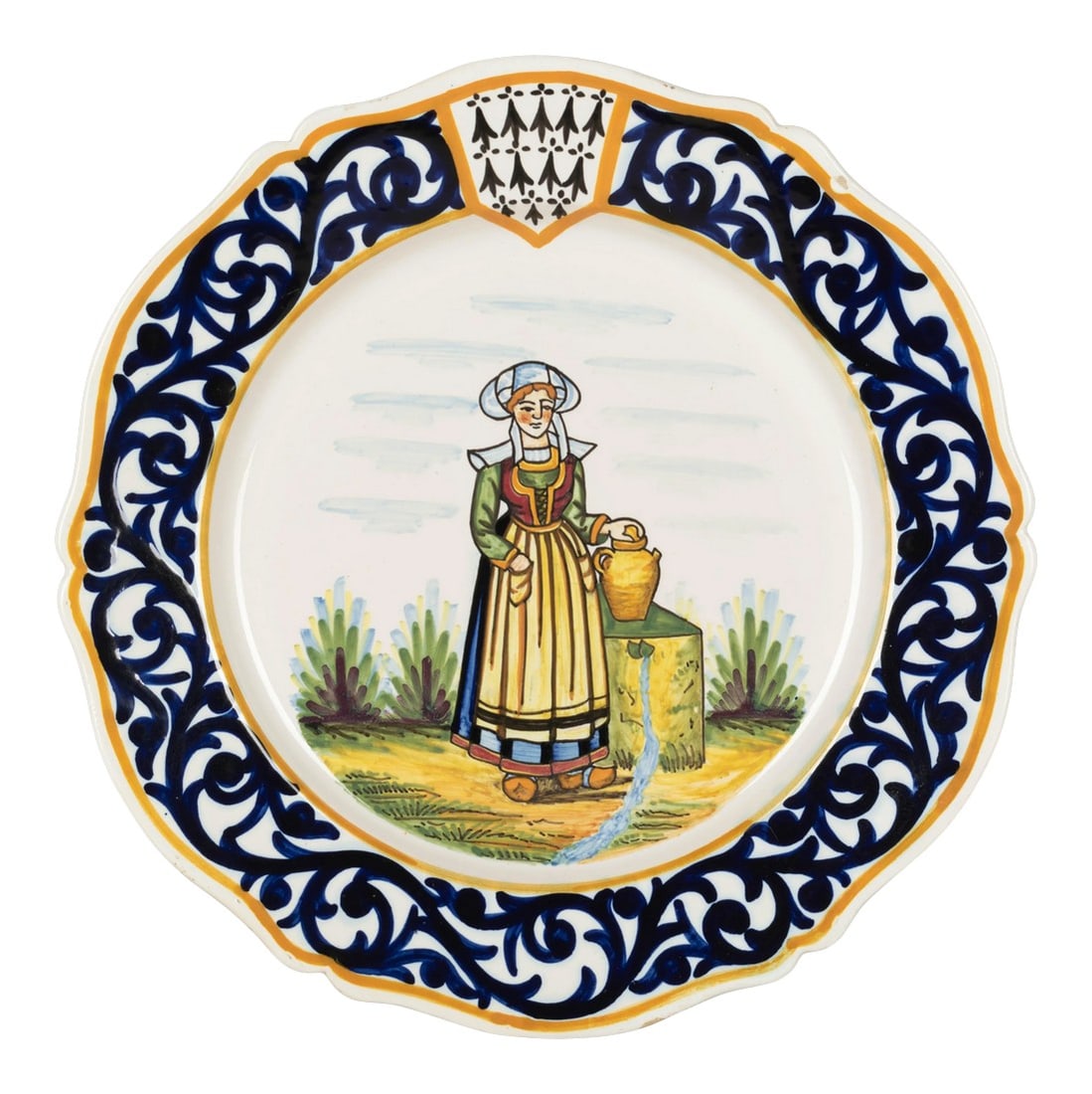Henriot Quimper Faience Plate: A Henriot Quimper French faience hand painted decorative plate, depicting a Breton woman in traditional dress standing beside a well with a water jug. Blue foliate border and with Quimper crest at