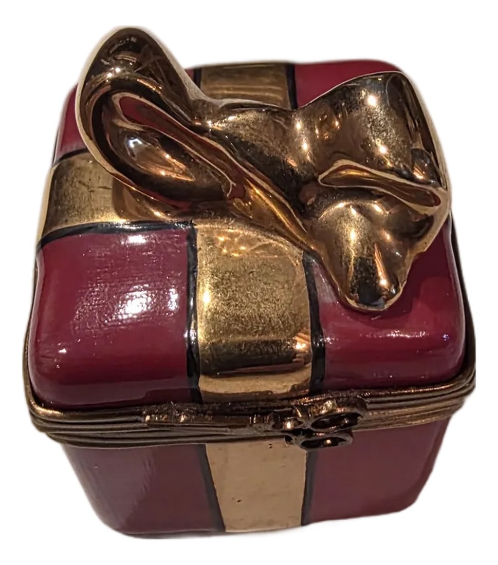 Small Limoges Porcelain Christmas or Gift Box: Great for giving a special Ring in or just adding it to a collection. Small red porcelain box with a gold ribbon and a bow at the top. Condition: Alterations: Original Condition Unaltered
