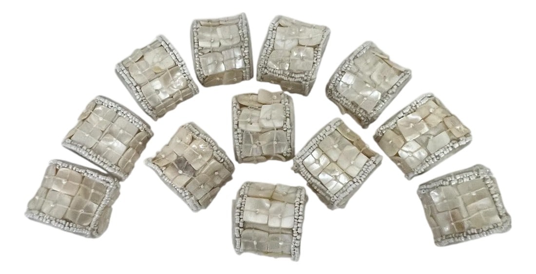 Late 20th Century Capiz Shell Mother of Pearl Napkin Ring - Set of 12: Set of 12 handcrafted capiz shell mother of pearl napkin rings. Beaded edges set off the center design of capiz shells which are sewn to the ring. Each measures 1.5" diameter x 1.75" w. A few of the c
