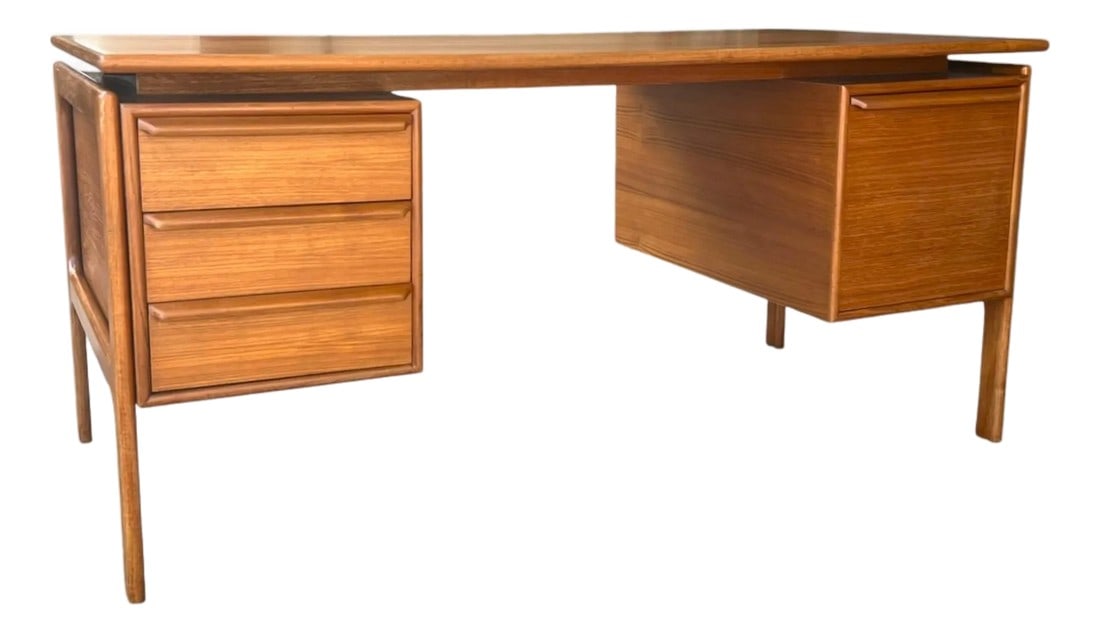 1960s Danish Modern Teak Floating-Top Desk With Pedestal Base and Drawers: This elegant Danish modern teak desk showcases clean architectural lines and timeless mid-century craftsmanship. Constructed from teak wood, the desk features a warm maple-toned finish sealed with a s
