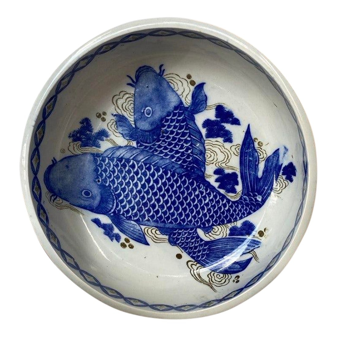 Japanese Edo Period Imari Bowl With Koi Motif, Circa 1780–1820: Hand-painted Japanese Imari porcelain bowl dating to the Edo period, decorated in underglaze cobalt blue with two expressive koi swimming among stylized waves and cloud scrolls. The composition