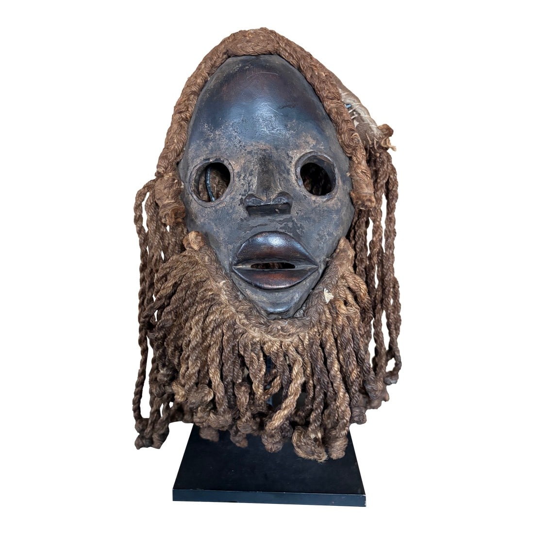Dan Mask 20th Century: Vintage Dan mask 20th century. Shows signs of wear ant tear from aging. Black in color with faded patina . 10 inches hight and 6 inches wide. Made from wood fiber and textiles. Provenance: from a priv