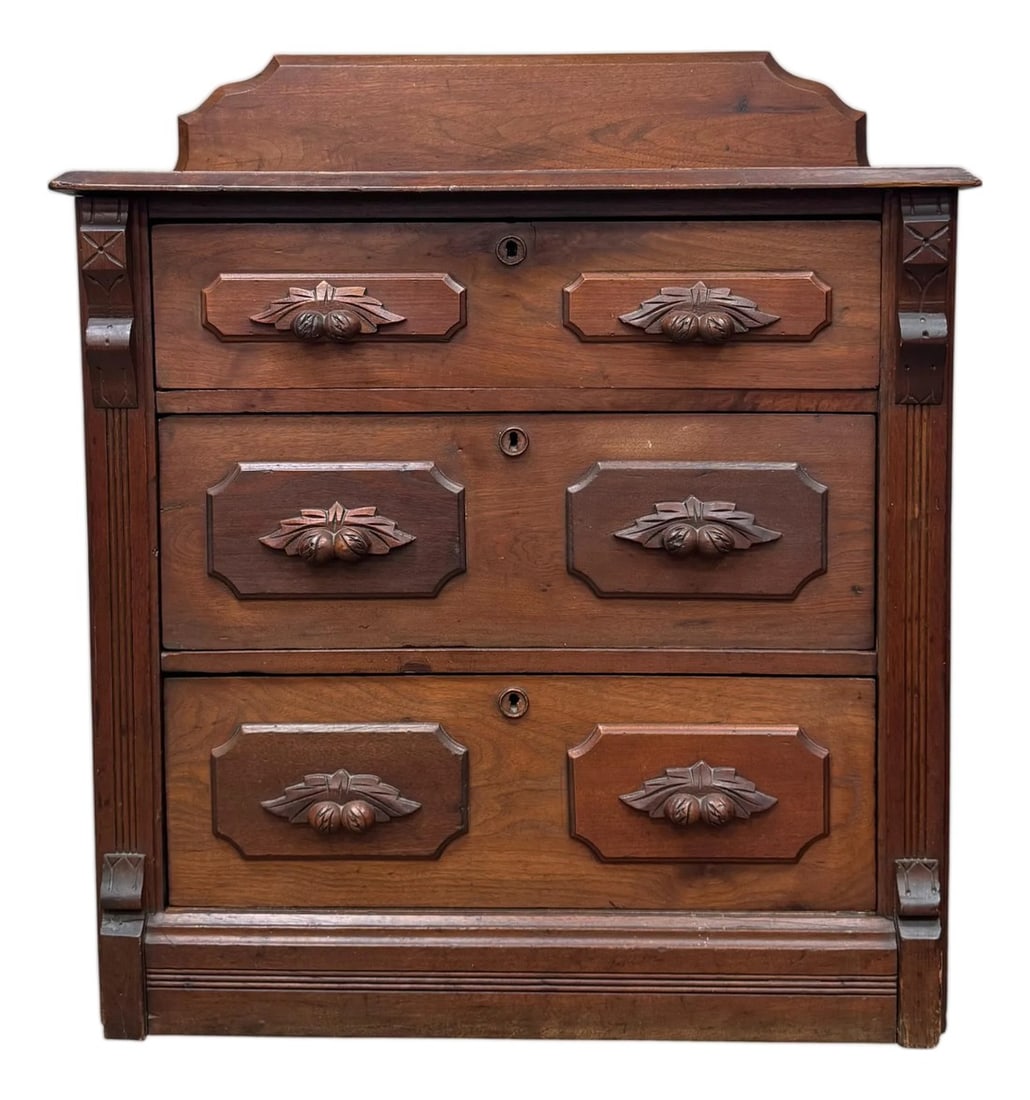 Antique Victorian Eastlake Commode: Dating to the 1880s, this beautifully crafted chest is constructed from solid walnut and exemplifies the geometric precision and linear ornamentation characteristic of the Eastlake movement. The piece