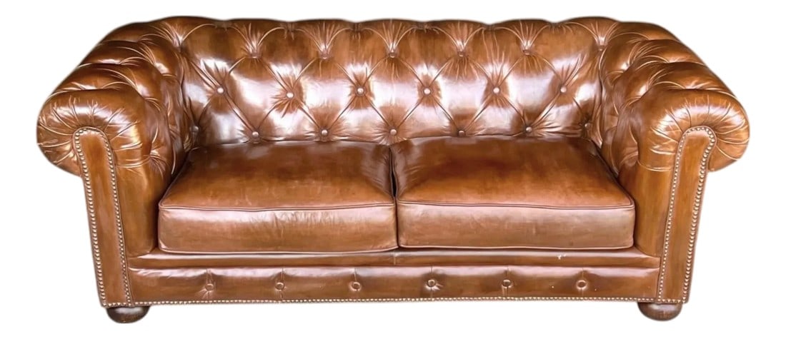 Vintage Chesterfield Tufted Leather Sofa, Fully Restored With Brass Nail Head Trim: This stunning vintage Chesterfield sofa has been completely restored and professionally newly dyed in a light brown color, revealing a beautiful luster and rich patina throughout. Featuring a classic