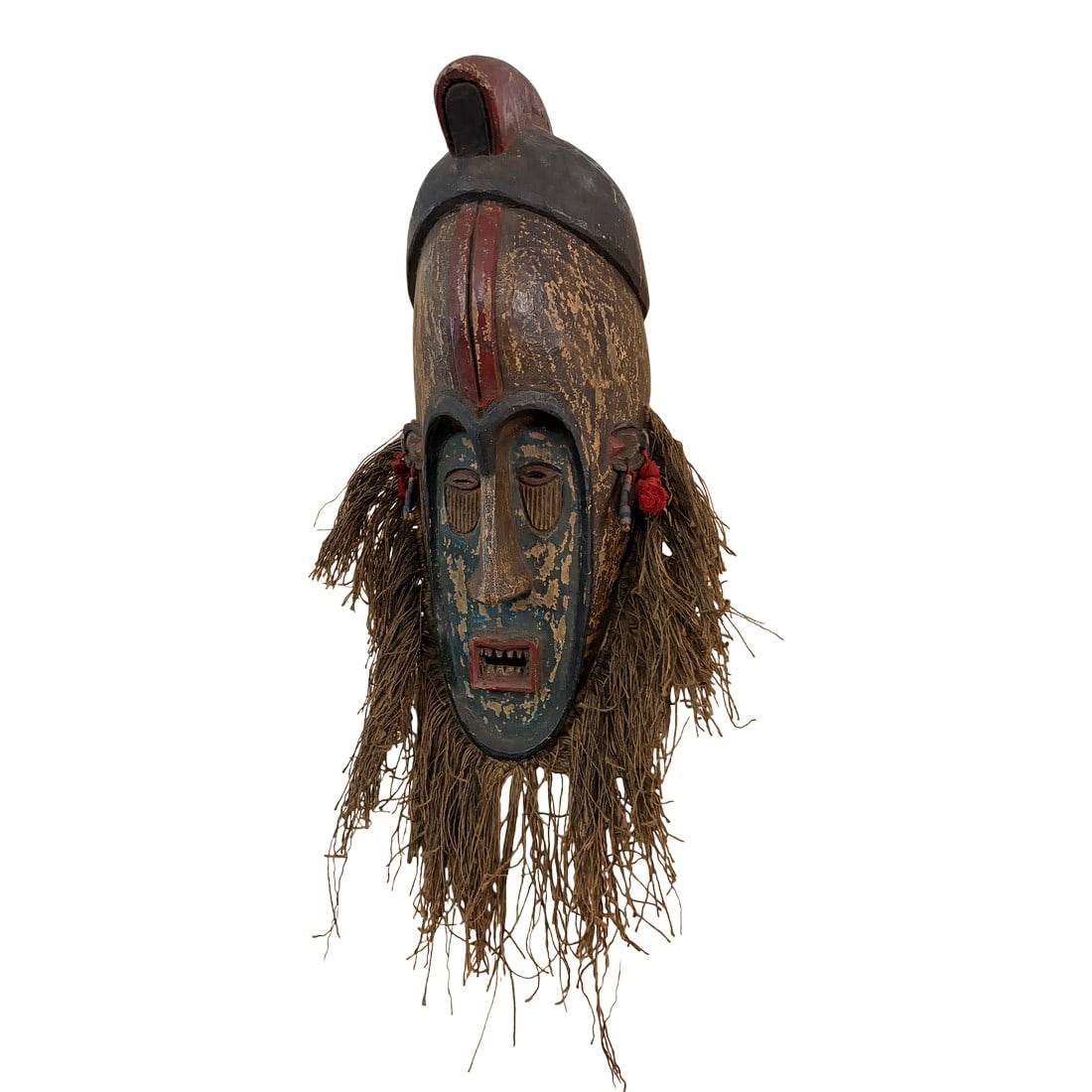 Fang Mask. 20th Century: This is a rare fang mask from Gabon . It is made out wood, fiber and beads. It is a mixture of black , tan and red in color . It measures 19.5 inches in height and 8 inches wide. There signs of wear a