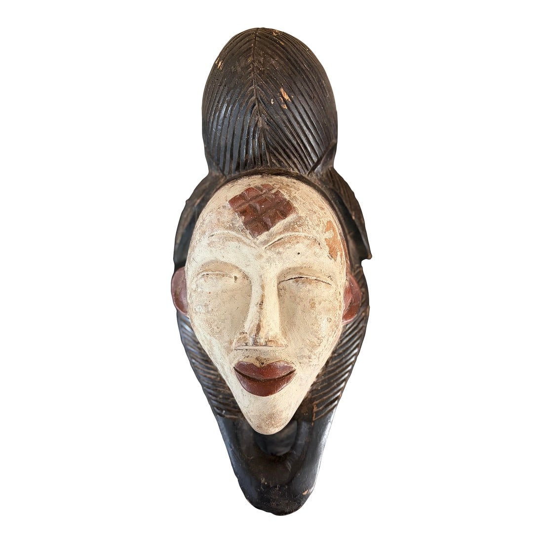Punu Mask 20th Century: This is a vintage African Punu mask from Gabon. It is made of wood. It was made in the 20th century It is white and brown in color. It shows signs of fading patina due to aging. Provenance: from a pri