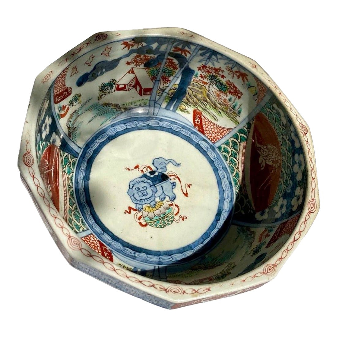 Large 19th Century Japanese Imari Octagonal Bowl With Karashishi & Landscape Panels: A striking late 19th century Japanese Imari porcelain octagonal bowl of generous scale and exceptional decorative complexity. The faceted form frames a richly painted interior divided into