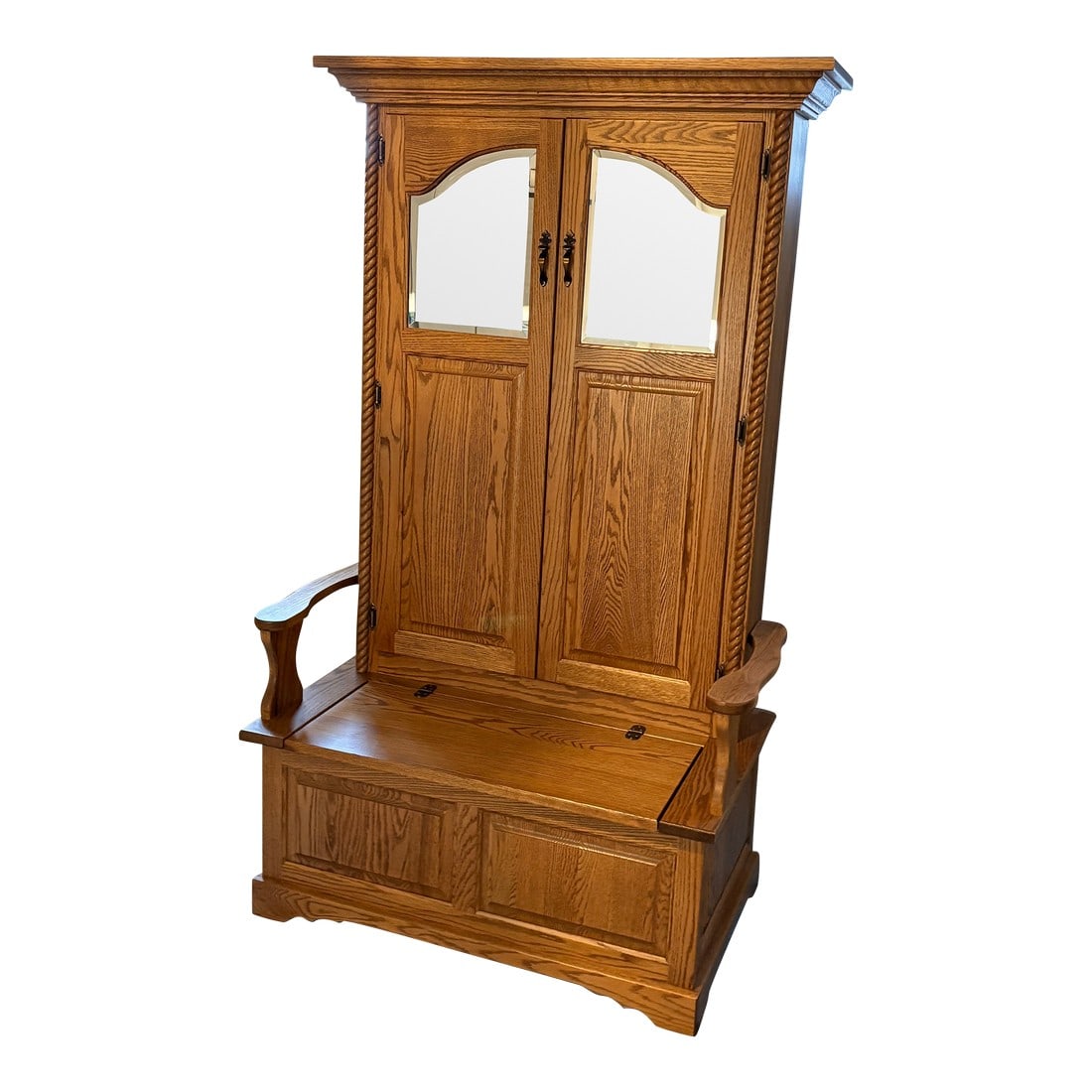 Traditional Oak Hall Tree With Built in Storage: Handsome large Amish style traditional oak hall tree bench with built in storage under the seat and door that opens to hooks for hanging coats. The mirror on the door adds a nice touch. Patrick Condit