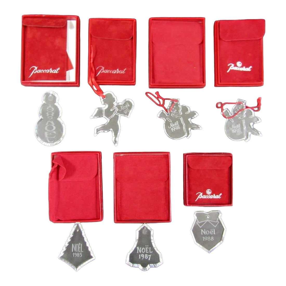 Baccarat Crystal Boxed Christmas Ornaments 1985, 1987, 1988, 1989, 1995, 1998: The Baccarat Crystal Boxed Christmas Ornaments from the years 1985, 1987, 1988, 1989, 1995, 1998 are a set of seven small, clear crystal ornaments perfect for collectors or those looking to add a