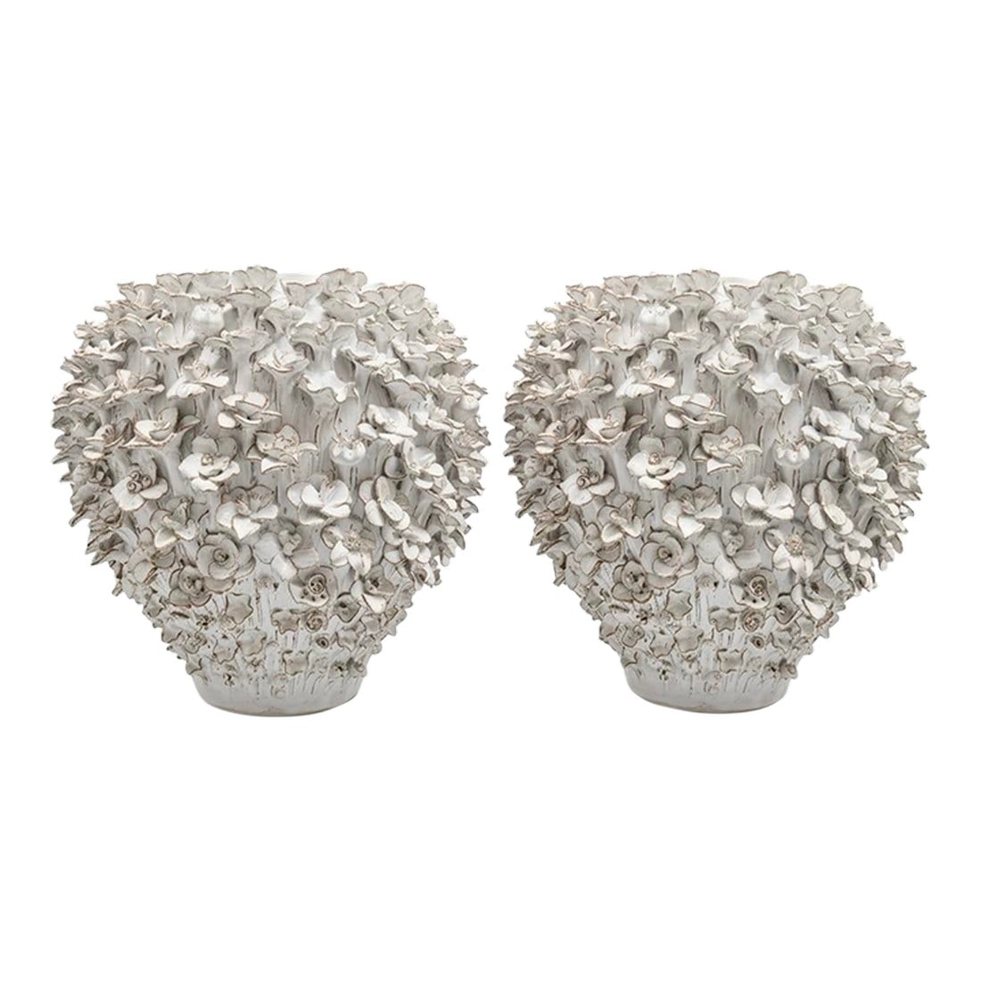 Pair of Hand Made White Floral Ceramic Vases: This exquisite pair of white ceramic vases showcases masterful craftsmanship, defined by hundreds of individually applied, hand-modeled blossoms. The monochromatic white glaze is accented by