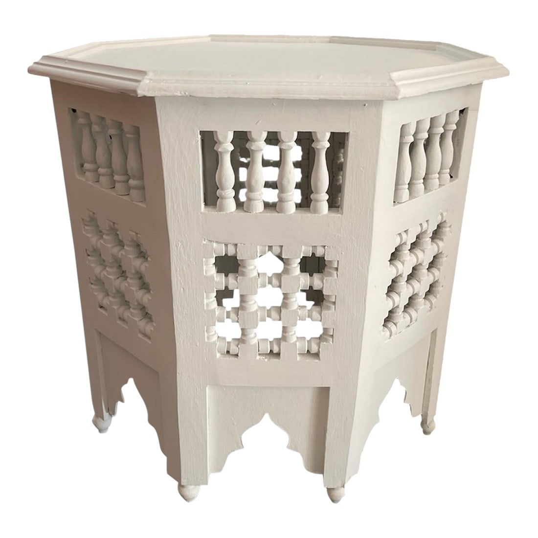 Hand-Carved Moroccan Octagonal Side Table: This octagonal side table is a testament to the storied woodworking traditions of Marrakech. Entirely handmade from solid wood, the piece features an architectural silhouette defined by intricate