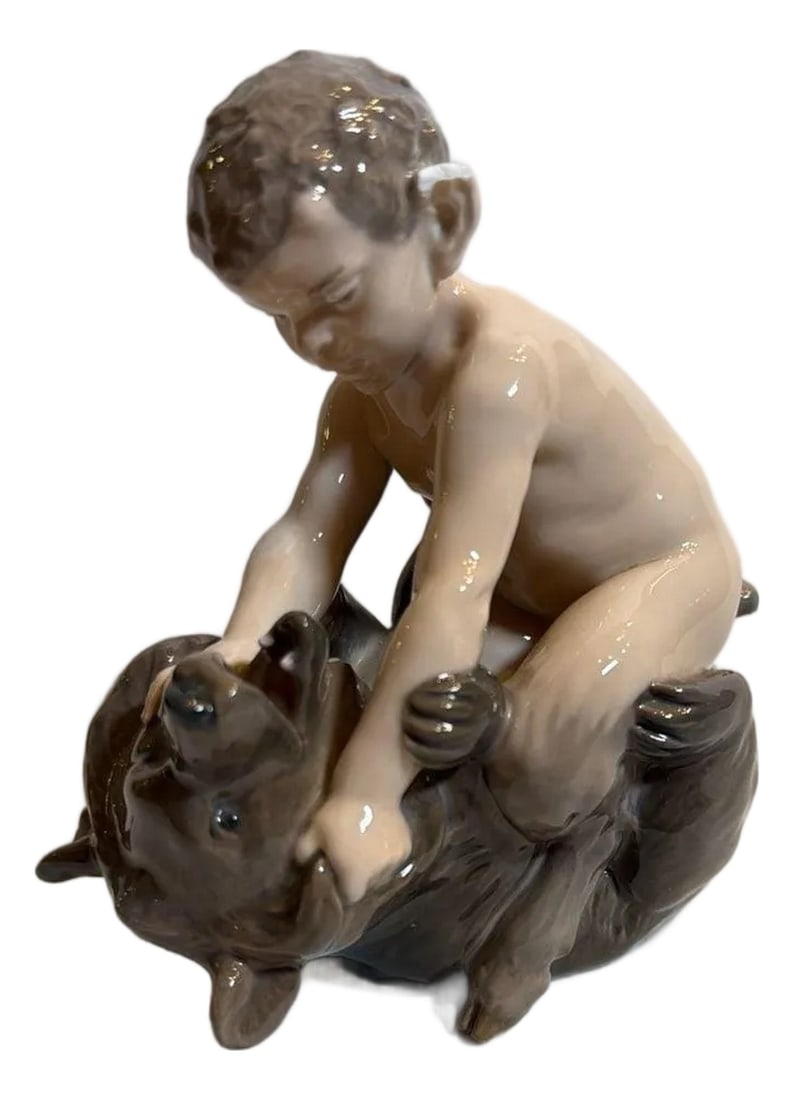 Mid 20th Century Royal Copenhagen Faun With Bear Porcelain Figurine #648: Vintage Royal Copenhagen Faun with Bear porcelain figurine, model #648. This classic Danish collectible features a satyr/faun playfully wrestling a bear cub, finished in the brand's iconic soft glaze