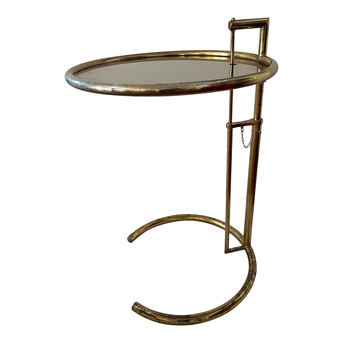 1980s Adjustable Brass Finished Metal & Tinted Glass Side Table, After Eileen Gray E1027 Table: After Eileen Gray's E 1027 adjustable round chrome and glass side table This one in a brass finish with tinted glass. Designed in 1927 for her modernist house in the South of France. The