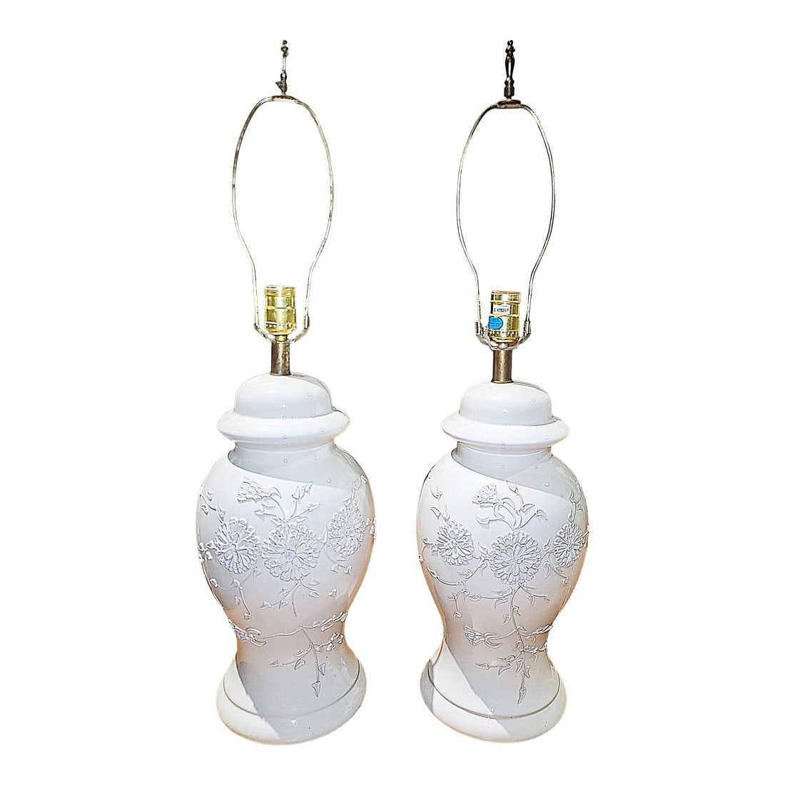 1970s Porcelain Floral Table Lamps - a Pair: We love these plump porcelain potbelly table lamps in a lovely soft white with raised porcelain floral decor on front. Ginger jar style, works well Condition: Alterations: Original Condition