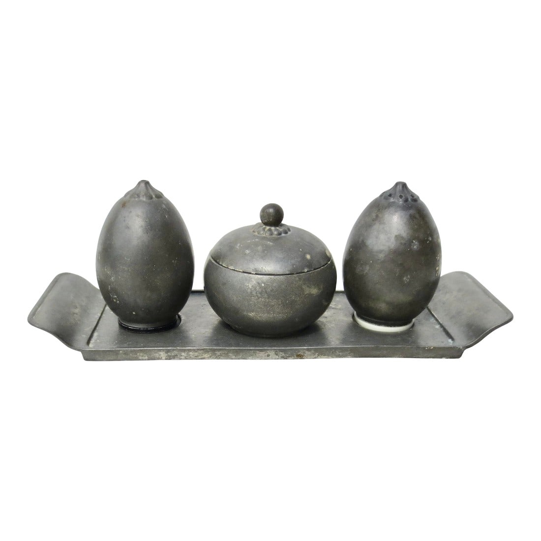 1930s Just Andersen Pewter Table Setting - Set of 4 Pieces: Danish designed set by Just Andersen in pewter from the '30s. Salt, pepper, and sugar pot with a lid on a fitted serving tray. Grey pewter cast with the JUST logo to undersides. Salt has a white