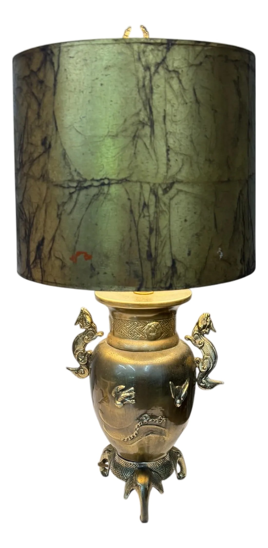 Vintage Chinoiserie Dragon Handle Table Lamp: Vintage chinoiserie brass lamp with dragon handles. Features a scene of flying birds on each side mounted on three elephant heads. The gilt faux marble board shade is also vintage and, as consistent