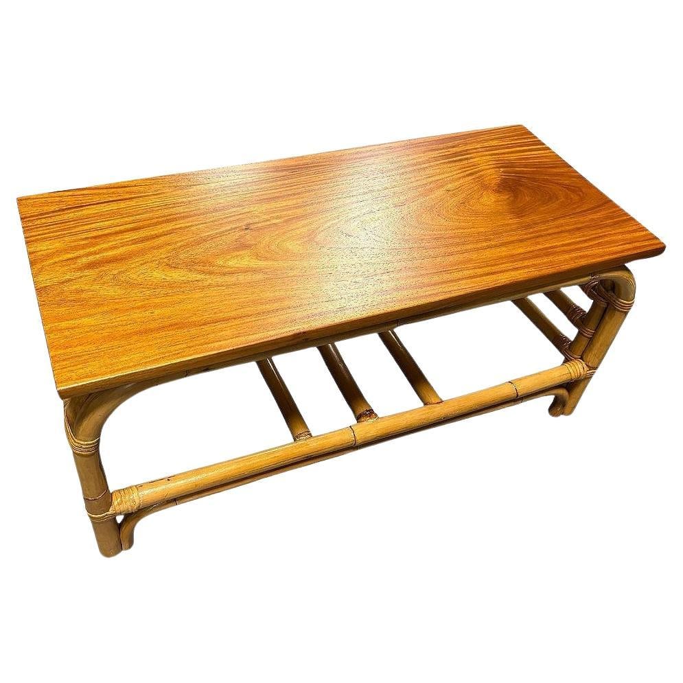 Restored 2-Tier Rattan Staple Base Coffee Table w/ Mahogany: Title: Restored 2-Tier Rattan Staple Base Coffee Table w/ Mahogany Description: This beautifully restored Paul Frankl-inspired staple base coffee table with large arches forming a double staple shape 