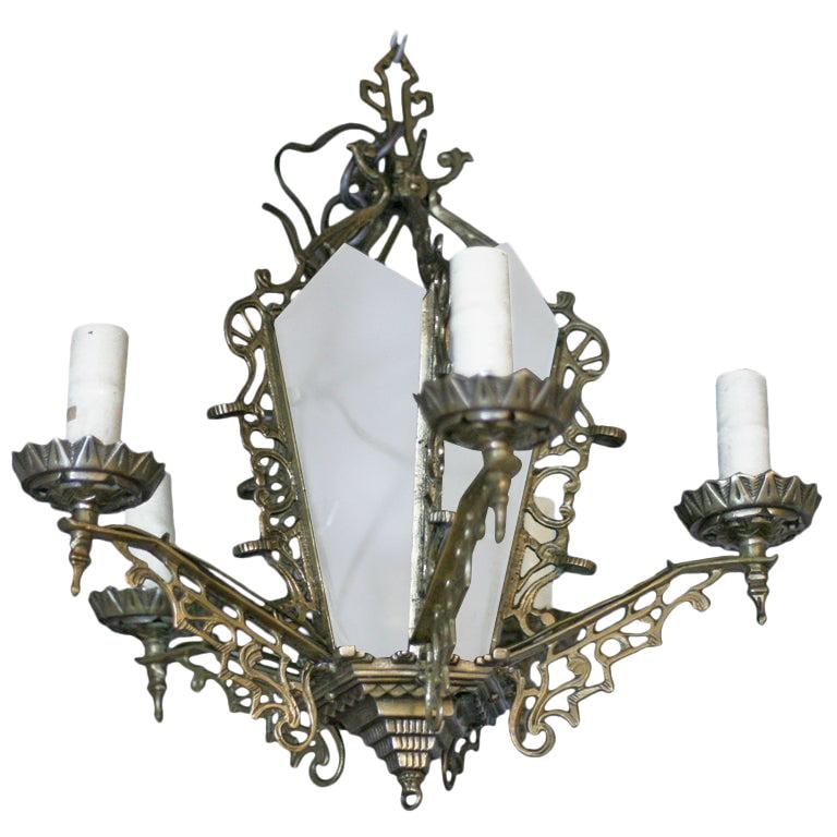 Art Deco Slat Glass Brass Dining Room Chandelier w/ Geometric Details: Title: Art Deco Slat Glass Brass Dining Room Chandelier w/ Geometric Details Description: Six-arm geometric Art Deco chandelier with candle-style lights and a light-up slat glass center. The piece