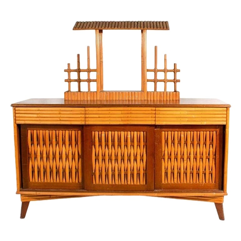 Mid-Century James Mont Inspired Rattan & Wicker Buffet Credenza: Title: Mid-Century James Mont Inspired Rattan & Wicker Buffet Credenza Description: This beautifully restored Rattan Credenza Media Console. Its distinctive design features woven front doors that add