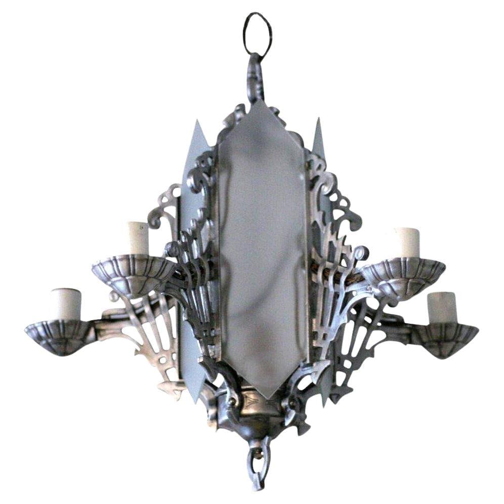 Art Deco Chandelier With Geometric Details and Frosted Glass: Title: Art Deco Chandelier With Geometric Details and Frosted Glass Description: Striking Art Deco chandelier featuring frosted glass panels and intricate geometric metalwork. The symmetrical design