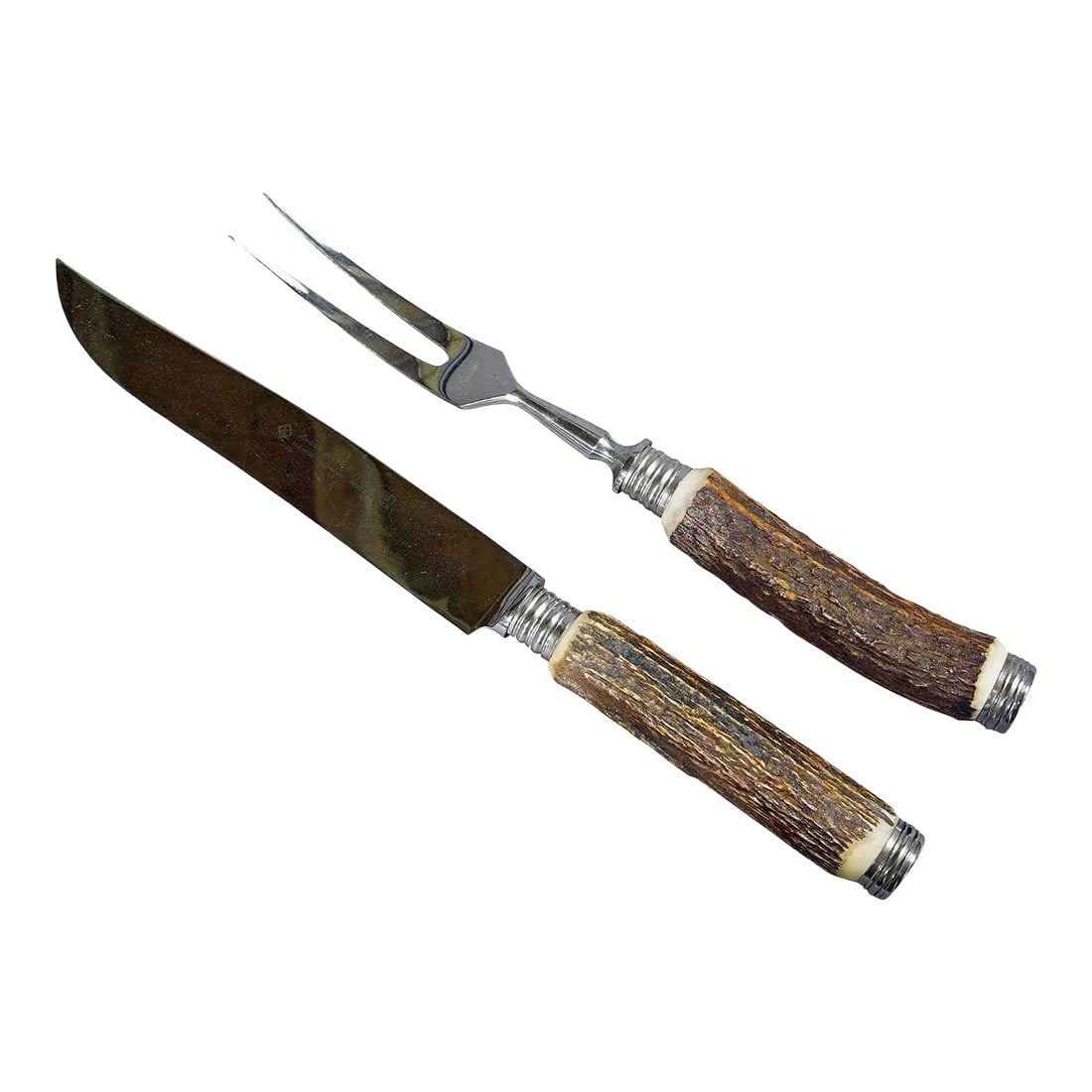 Vintage Stag Horn Carving Set Solingen, Germany: Vintage Stag Horn Carving Set Solingen, Germany A rustic carving set consisting of fork and knife. The handles are made of genuine stag horn and feature a silver knob on their ends. Blade and fork mad
