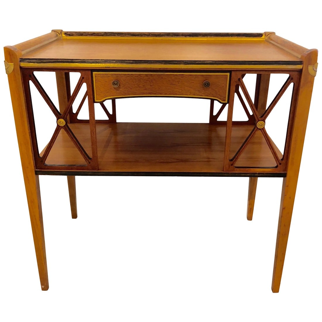Neoclassical Style Side Table With Drawer: A very elegant neoclassical style side table having light brown wood offset with ebonized and painted sections as well as gold leaf. There are stunning X's on the front and back, elegant tapered