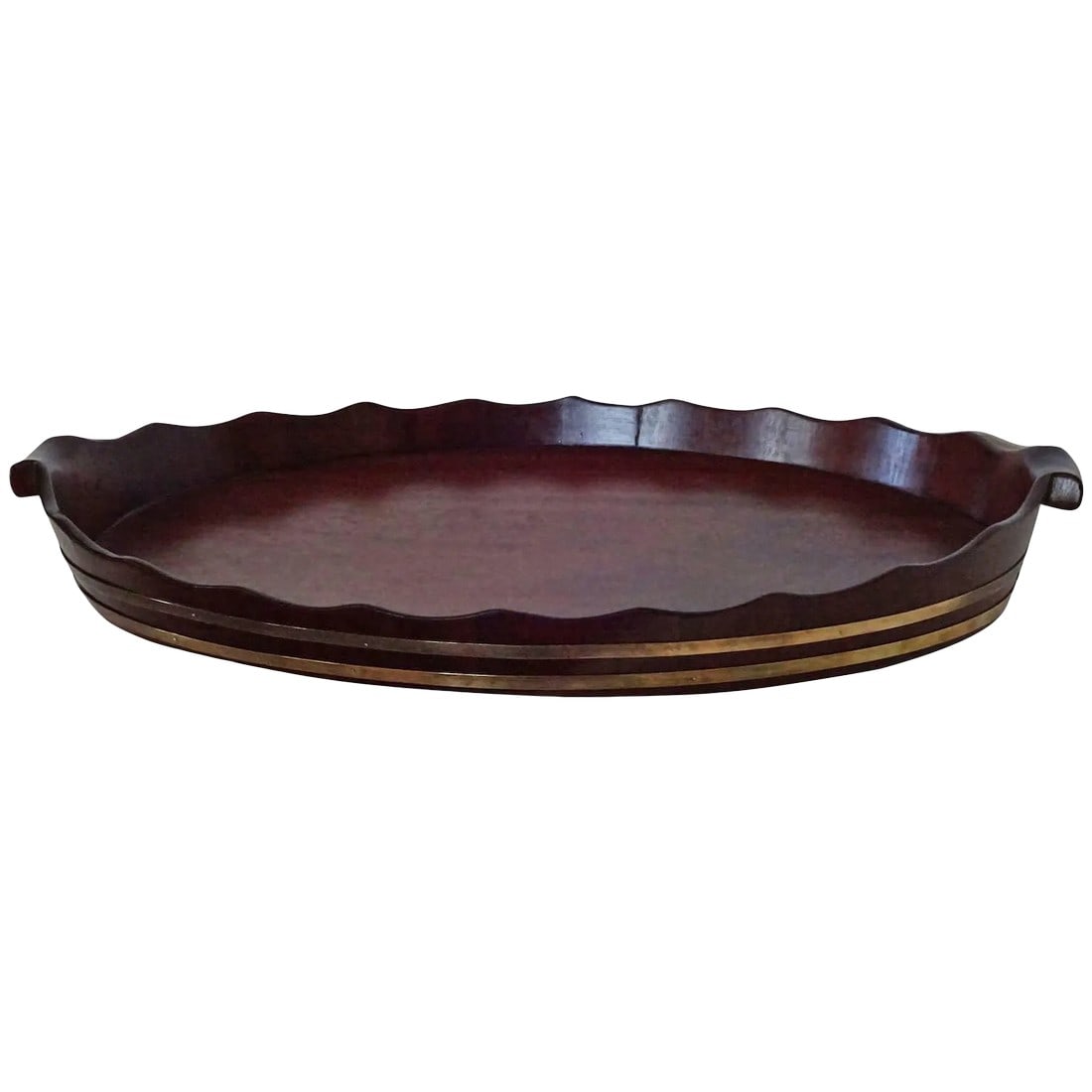 Large George III Oval Mahogany Tray With Fluted Edge: A wonderfully large double brass-banded George III mahogany tray with graceful fluted pie-crust edge and hand-carved handles. Recently polished and ready to serve. The height below includes the
