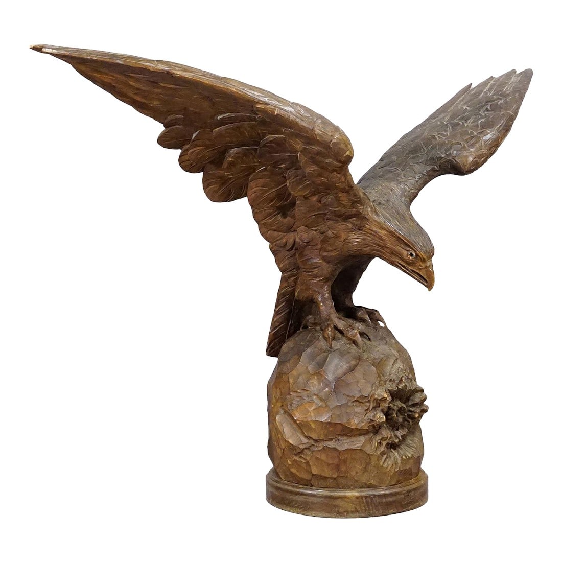 Large Hand-Carved Statue of an Eagle, Black Forest Ca. 1900: Large Hand-Carved Statue of an Eagle, Black Forest ca. 1900 An expressive naturalistic carved large eagle sculpture. The eagle is sitting on a rock and has spread its wings. The wingspan of the wings