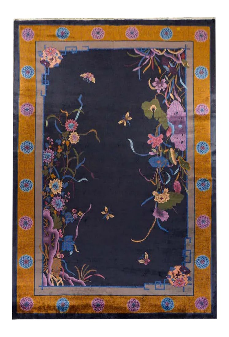 Chinese Art Deco Rug: A gorgeous early 20th century Chinese Art Deco rug with large clusters of multicolored lotus and chrysanthemums in each corner on dark indigo background. The border is exciting with a wide gold