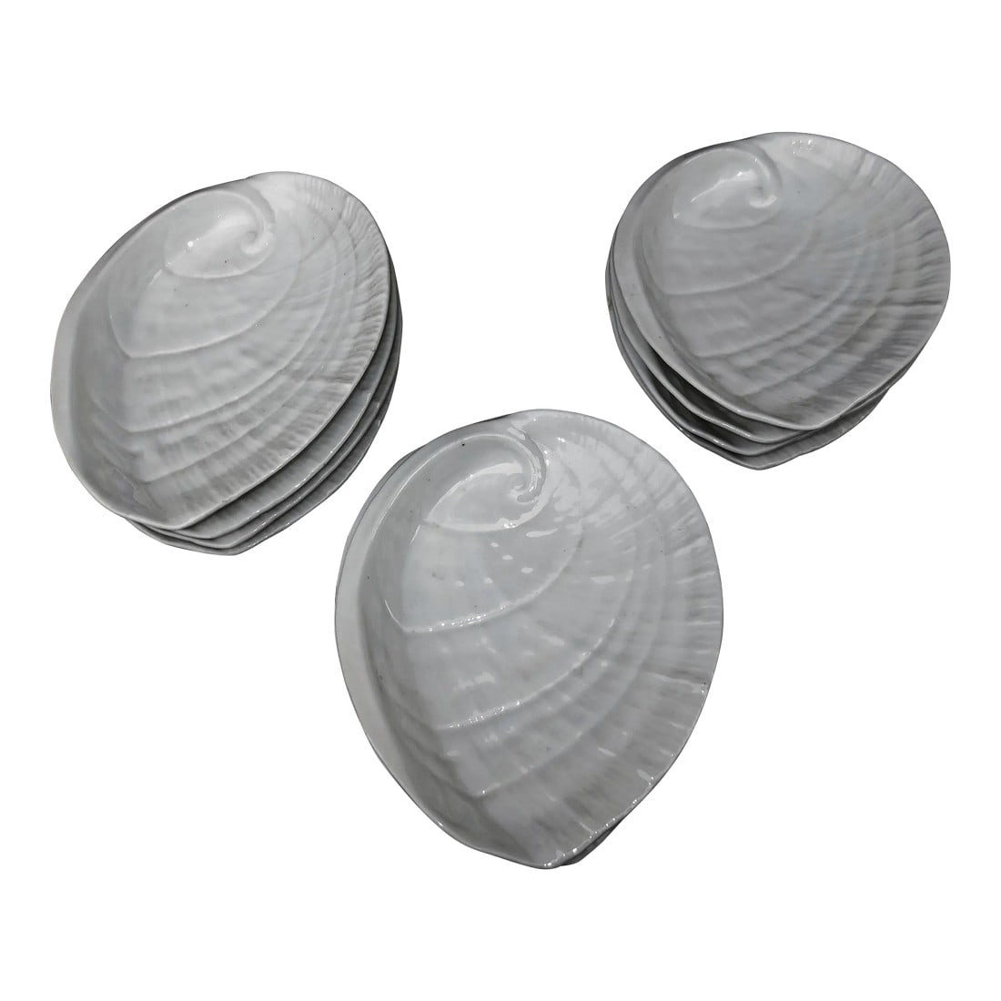 White Porcelain Abalone Shell Salad Plates - A Set of 10: A set of 10 porcelain abalone-shaped shell dinner or salad plates. White with a slight rainbow irredescence. The plates have no maker marks on the bottoms, but they are likely from a German or