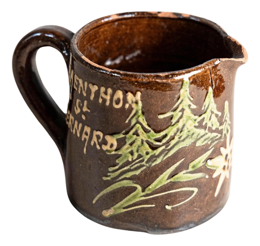 19th Century French Savoyard Souvenir Pitcher – Menthon-Saint-Bernard: A small, rustic French souvenir pitcher from the 19th century, originating from Menthon-Saint-Bernard, a picturesque village nestled in the Haute-Savoie region near Lake Annecy. Handcrafted in terraco